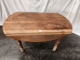 an image of a small wooden table with a white sticker on it