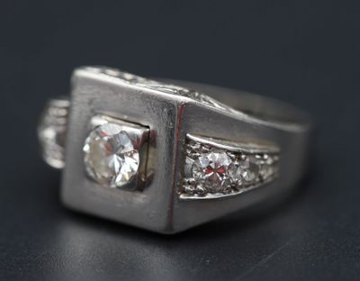 une image d'une bague en diamant sur une surface noire