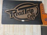 a sign that says road trip cafe on the side of the building