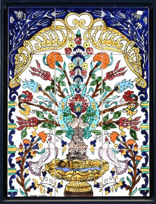 an ornately painted tile with flowers and birds in a vase