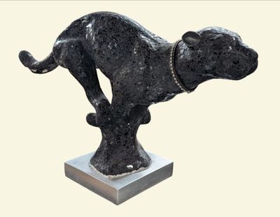 statue of a dog on a pedestal with a chain around its neck