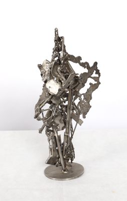silver metal sculpture of a man with a clock on his arm