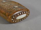 a small wooden box with a decorative design on it