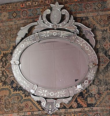 un miroir posé sur un tapis orné d'un oiseau