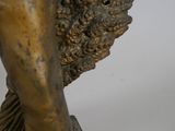 bronze statue of a boy with a basket of grapes