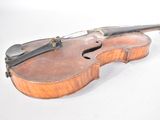 a violin that is sitting on a white surface