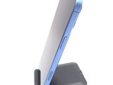 the back of a blue and white cell phone on a stand