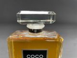 an image of a bottle of coco coco perfume on a table
