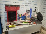 a table with tools on it in front of a wall