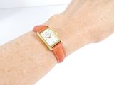 a woman ' s wrist that has a watch on it