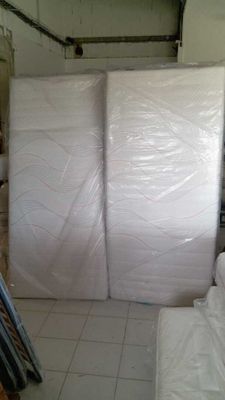 a room with a lot of white mattresses in it