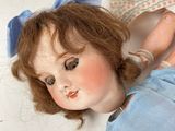 a doll that is laying down on the ground