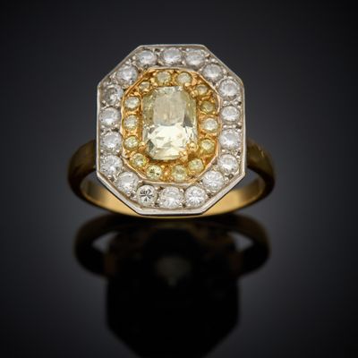 a yellow and white diamond ring set in 18k gold