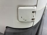 a close up of a door handle on a white truck
