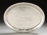 a silver plate sitting on a table with a black background