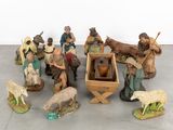 many figurines of people and animals on the floor