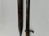 an old knife and a small knife on a white surface