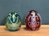 two eggs that are sitting on a wooden table