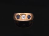a close up of a gold ring with a diamond and sapphire stones