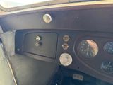 a close up of a dashboard with a clock on it
