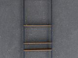an overhead view of a ladder leaning against a concrete wall