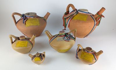 several pieces of pottery sitting on top of a white surface