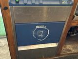 a blue and silver dishwasher sitting on a wooden shelf