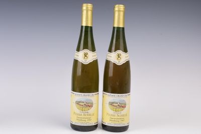 two bottles of wine sitting next to each other on top of a table