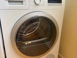a washer and dryer in the corner of a room