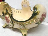 a decorative bowl with a bird on it on a table