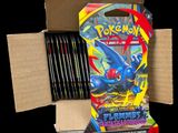 a box of pokemon trading cards sitting on top of a cardboard box