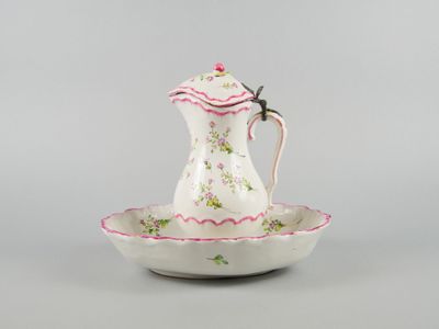 an image of a white and pink teapot on a saucer