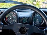 a steering wheel and gauges in a car