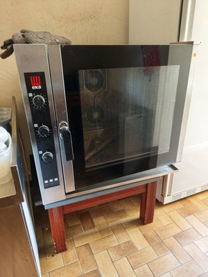 a microwave that is sitting on a stand in the kitchen