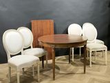 four chairs and a table in a room with a black wall