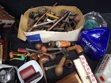 a box full of old tools and other items on a table