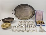an assortment of silverware including a tray, spoons, and other items