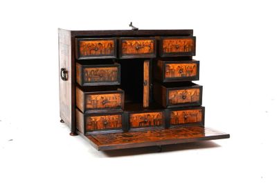 a small wooden cabinet with many drawers on it