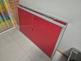 a red door in a room with a brick wall