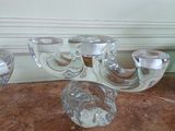 four glass candlesticks sitting on a marble table