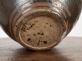 a close up of a vase on a wooden table