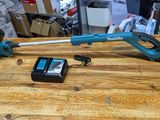 a blue cordless stringing machine on a wooden table