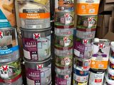 many cans of paint stacked on top of each other