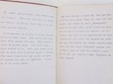 someone is holding a book open to a page with writing on it