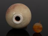 an image of a vase and an apple on a black surface
