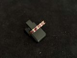 pink and white diamond ring on a black surface