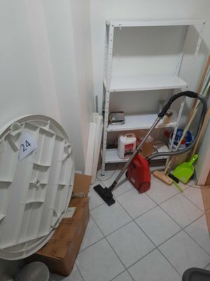 a toilet in the corner of a room with a trash can in it