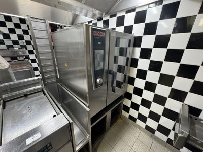 a kitchen with a checkered wall and stainless steel appliances