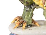 a figurine of a bird that is sitting on a table