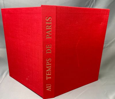 a red book sitting on top of a white cloth covered table